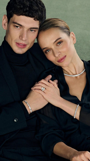 Man and woman embracing, wearing Stephea Brave Collection, against a neutral background